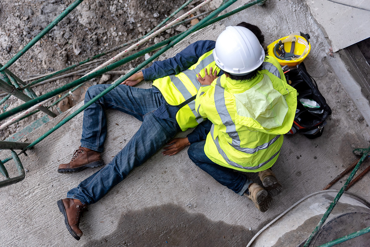 First aid support accident at work of construction worker at site. Builder accident falls scaffolding on floor
